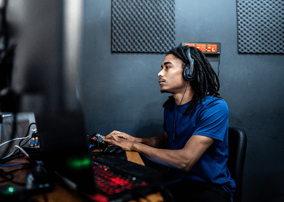 audio_over_ip Audio engineer wearing headphones at a desk