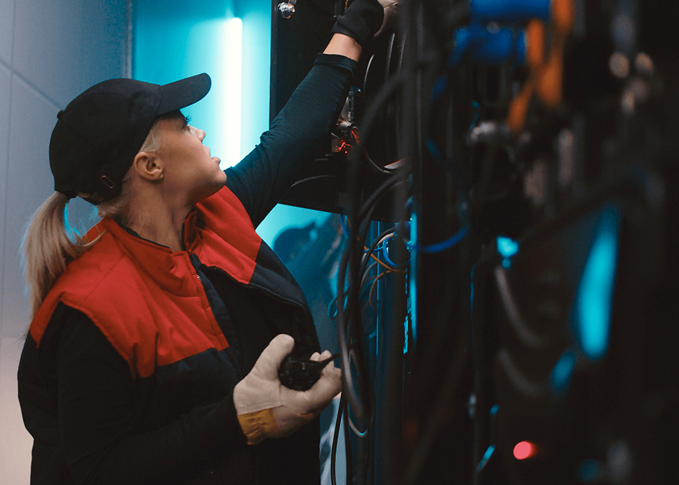 female av technician speaking on radio and examining wires