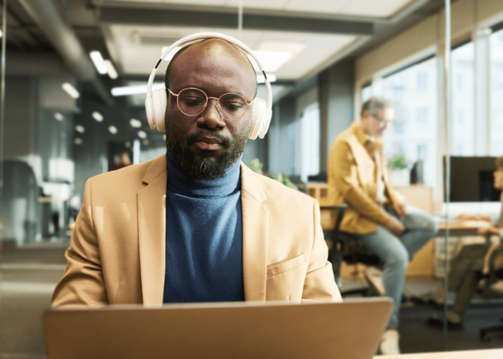 lossless_audio Man wearing headphones in office